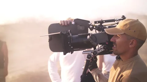 Filming in the steppe. The operator moves the video camera. Film crew Stock Footage 322797788