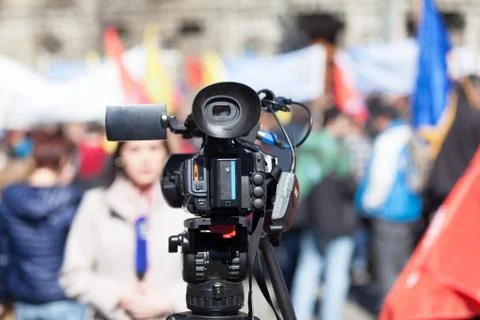 Filming street protest using a video camera Stock Photos