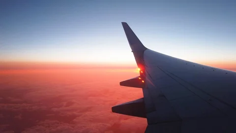 Filming a sunset inside from a plane Stock Footage 116266324