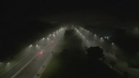 Filming two streets into the mist at night time Stock Footage 229114156