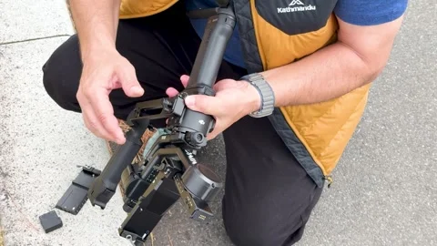 Filmmaker Setting Up Professional Camera Gimbal Stabilizer in Tokyo Japan Stock Footage 331491299