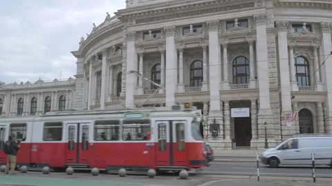 Filmmaker using three axis gimbal to film passing old tram in Vienna Stock Footage 82332547