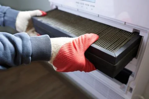 Filter change. The concept of supplying fresh air into the house. Stock Photos