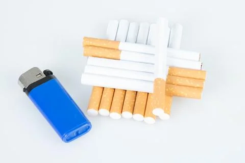 Filter cigarette stack in pyramid with blue lighter isolated on white Stock Photos