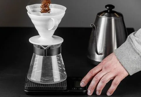 Filter coffee brewing on black background. Pour-over alternative method of .. Stock Photos