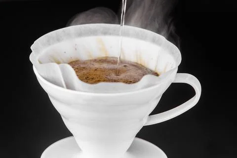 Filter coffee brewing on black background. Pour-over alternative method of .. Stock Photos
