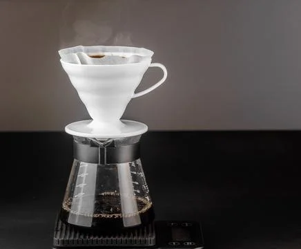 Filter coffee brewing on black background. Pour-over alternative method of .. Stock Photos