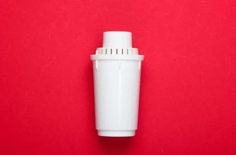 Filter element of water purifier on red background. Top view Stock Photos