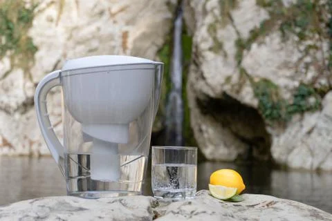 Filter jug as a way to solve the problem of shortage of fresh drinking water Stock Photos