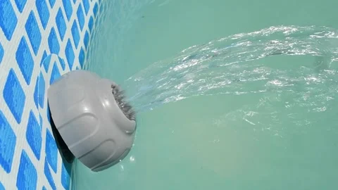 Filter pump delivers clean water into frame pool, creating powerful flow and Stock Footage 300991081