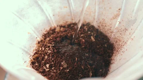 Filter V60 coffee. Hot water spilling fine jet in paper filter with ground 스톡 동영상 169524155