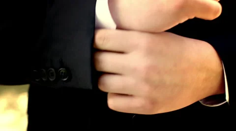 Filtered close up of man adjusting suit and tie outdoors 4K Stock Footage 51262480