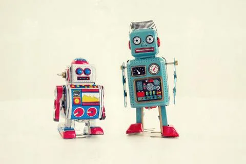 Filtered vintage tin toy robots isolated on white background 库存照片