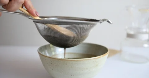 Filtering coffee using metal filter net Stock Footage 107574830