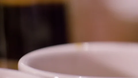 Filtering out grounds from coffee cu. Pour over into mugs D Stock Footage 123873394