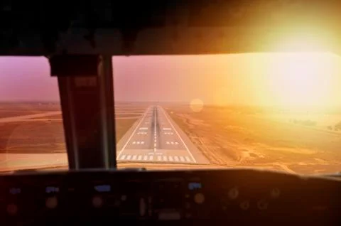 Final approach during sunset. View from flight deck Stock Photos
