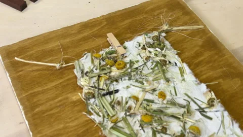 Final craft result: handmade floral paper mounted on stained wood board, surroun Stock Footage 313519117