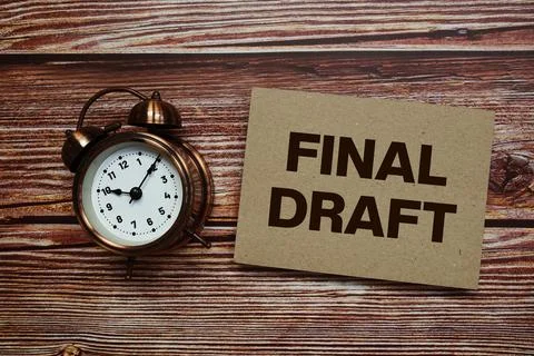 Final Draft text with alarm clock on wooden background Stock Photos