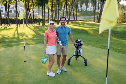 Final Flag Approach: Young Pair with Golf Bag Fotos Stock