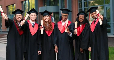 This is final. Full length view of the group of students at the graduation gowns Stock Photos