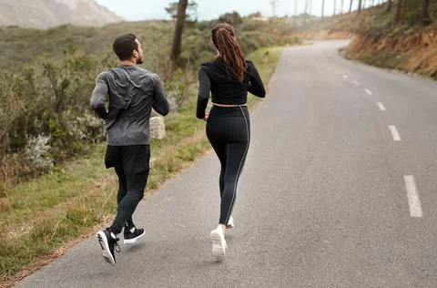 Final jog home. Full length shot of two unrecognizable athletes bonding together Stock Photos