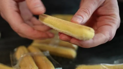 Final preparation of ladyfinger biscuits for a dessert Stock Footage 317135931