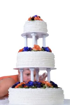 Final retouching ruffled wedding cake Stock Photos