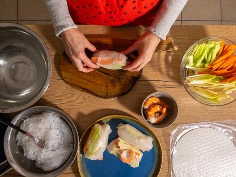 Final rolling step of fresh spring rolls with shrimp Stock Photos