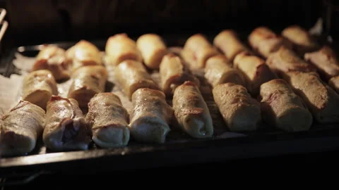 Final Stage of Baking Golden Meat Crepe Rolls Inside the Oven Stock Footage 332159753