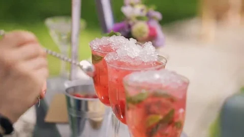 Final stage of preparing cocktail strawberry mojito for banquet Stock Footage 69193522