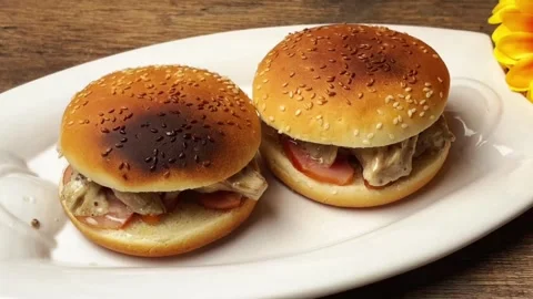 Final step of burger assembly with creamy oyster mushrooms and smoked meat Stock Footage 325032451