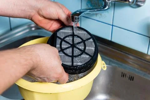Final step of cleaning kitchen sink filter under tap water Stock Photos