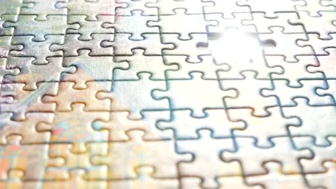 Final step to whole picture. Background of jigsaw puzzle. Last jigsaw puzzle Stock Footage 133517157