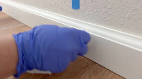 Final Touch on Baseboard Trim with White Putty Stock Footage 322081993