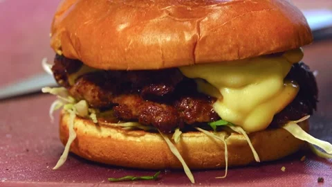 Final Touch: Perfect Assembly and Presentation of a Mouthwatering Gourmet Burger Stock Footage 288690986
