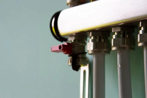 Final warm floor, modern heating system. Manifold with hanging pipes Stock Photos