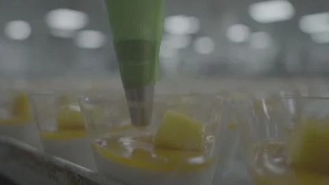 Finalizing mango mousse treats with a piping bag Stock-Footage 327357341