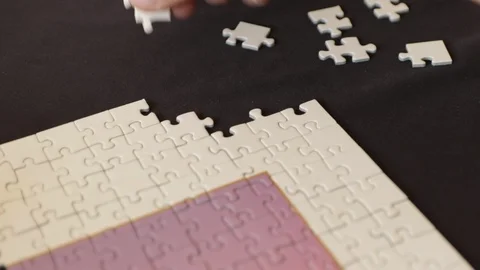 Finally putting the last pieces to a jigsaw puzzle Stock Footage 94479567