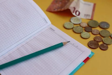 Finance. accounting and control notepad, pencil and money 10 euros and cents Stock Photos