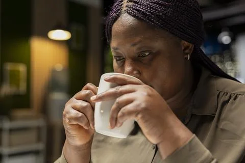 Finance advisor forecasting predictions while drinking a coffee in dark office Stock Photos