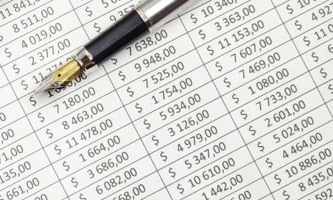 Finance analysis concept - a chart with a pen and on wooden desk Stock Photos