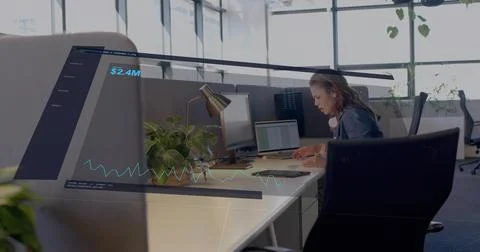 Finance analyst analyzing onscreen data, typing and checking notes while AR $2 Stock Photos