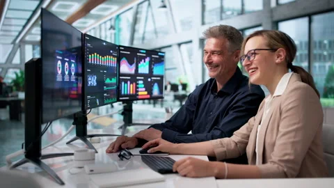 Finance Analyst And Coworker Sharing A Joyful Moment During Stock Footage 335876261