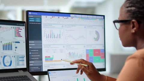 Finance Analyst Reviewing Dashboard Data On Laptop 動画素材 345852977