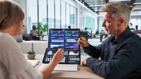 Finance Analysts Reviewing Dashboard Data Together Stock Footage 337226077