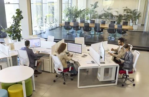 Finance analysts team working on data reports at modern open plan office Stock Photos