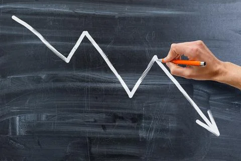 Finance business graph. Declining Line graph drawn with chalk on blackboard Stock Photos