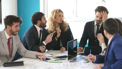 Finance, business-young manager explains points of the report to his colleagues Stock Footage 140629032