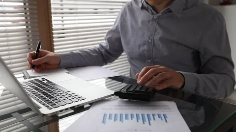 Finance calculation and management, calculating revenue Stock Footage 119916619