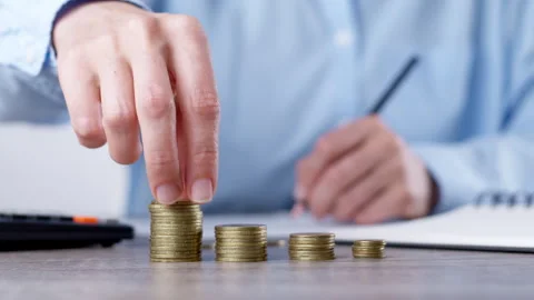 Finance concept. Hands using calculator on business desk and coins. Stock Footage 252687687